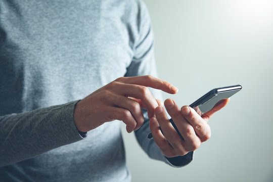 A phone on a nightstand, ready for a first text.